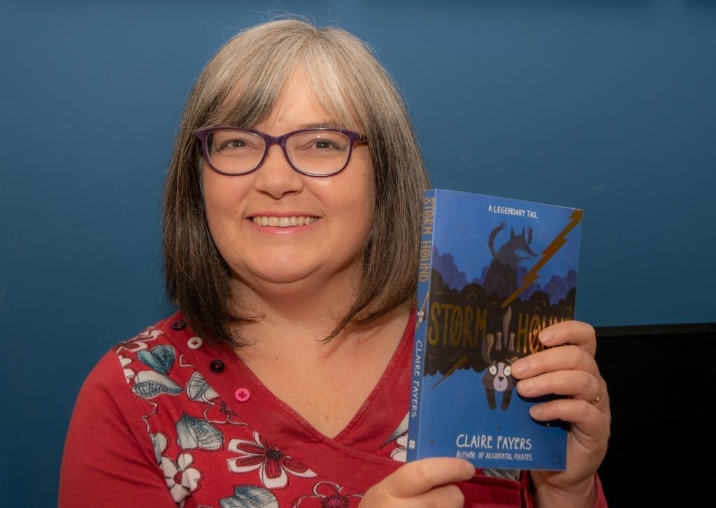 Claire Fayers holding a copy of her novel Storm Hound which won the English-language prize in the Tir na n-Og Awards 2020