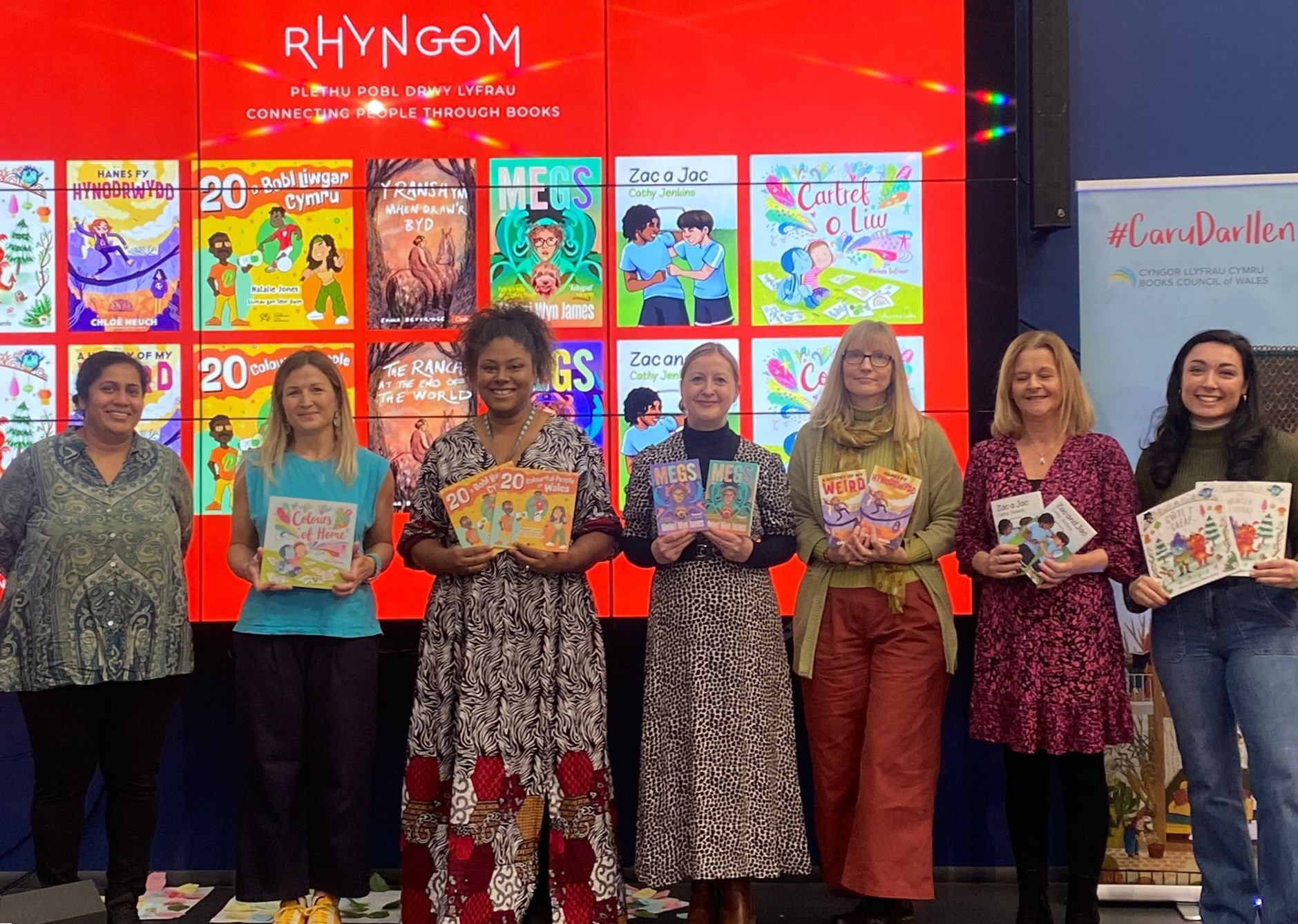 The authors of the Rhyngom project pose with the books that they have written.